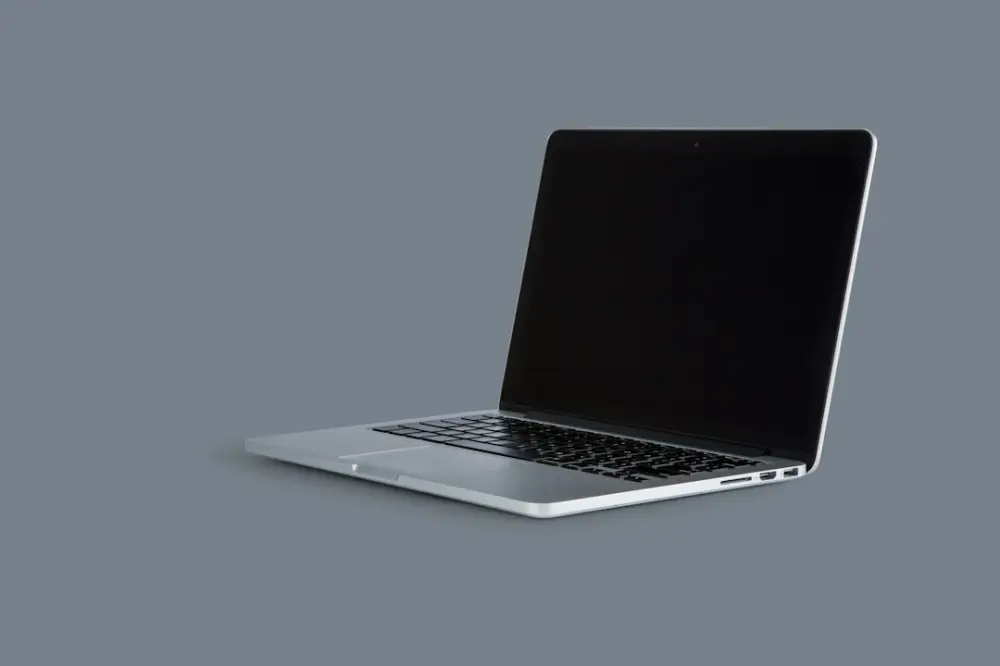 An open laptop computer sitting on top of a table, illustrating academic e-journals